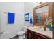 Bathroom with vanity, sink, toilet, framed mirror, and an enclosed shower at 2102 Congress Ln, St Cloud, FL 34769