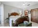 Cozy bedroom with elegant wood-frame bed and bathroom access door at 2102 Congress Ln, St Cloud, FL 34769