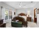 Spacious bedroom featuring an ornate wood-frame bed, neutral walls, and a bright window at 2102 Congress Ln, St Cloud, FL 34769