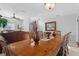 Formal dining room showcasing a large wood table with decorative chairs and an open view to the living area at 2102 Congress Ln, St Cloud, FL 34769