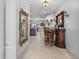 Elegant foyer with tile flooring, decorative mirrors, and a glimpse into the kitchen at 2102 Congress Ln, St Cloud, FL 34769