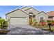 Charming single-story home featuring a lush, landscaped front yard and a two-car garage at 2102 Congress Ln, St Cloud, FL 34769