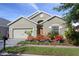 Attractive home boasts lovely landscaping, a two-car garage, and a well-maintained lawn at 2102 Congress Ln, St Cloud, FL 34769