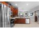 Bright kitchen with stainless appliances, a mosaic backsplash, and an open view to the living area at 2102 Congress Ln, St Cloud, FL 34769