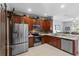Well-lit kitchen with stainless steel appliances, granite countertops, and dark wood cabinetry at 2102 Congress Ln, St Cloud, FL 34769