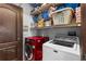 Functional laundry room featuring storage shelves, a washing machine, and a dryer at 2102 Congress Ln, St Cloud, FL 34769