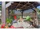 Inviting outdoor patio with a covered pergola, multiple chairs, and a center table at 2102 Congress Ln, St Cloud, FL 34769