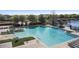 Large community pool area with plenty of seating and beautiful landscaping near a lake at 2102 Congress Ln, St Cloud, FL 34769