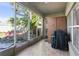 Enclosed porch with tile flooring, offering a view of the landscaped backyard and outdoor foliage at 2102 Congress Ln, St Cloud, FL 34769