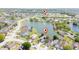 Aerial view of a lakeside community with home marked near a lake, playground, and recreational area at 2150 Flintlock Blvd, Kissimmee, FL 34743