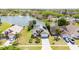 An aerial view of a well-kept home with solar panels, lush lawns, and scenic water views in a desirable neighborhood at 2150 Flintlock Blvd, Kissimmee, FL 34743