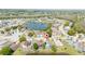 Aerial view highlighting a home's location with a pool, positioned by a lake in a residential community at 2150 Flintlock Blvd, Kissimmee, FL 34743