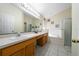 Bright bathroom features dual sinks, a soaking tub, and a separate shower at 2150 Flintlock Blvd, Kissimmee, FL 34743
