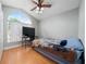 Well-lit bedroom with wood floors, a ceiling fan and arch window at 2150 Flintlock Blvd, Kissimmee, FL 34743