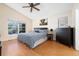 Tranquil bedroom with window overlooking backyard, wood floors, ceiling fan, and natural light at 2150 Flintlock Blvd, Kissimmee, FL 34743