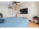 Cozy bedroom with wood floors, ceiling fan, and large window, perfect for relaxation at 2150 Flintlock Blvd, Kissimmee, FL 34743