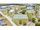 Aerial view of community amenities including tennis courts, skating rink, playground and a tranquil lake at 2150 Flintlock Blvd, Kissimmee, FL 34743