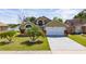 Inviting single Gathering home showcasing well-manicured lawn, 2 car garage, and mature landscaping at 2150 Flintlock Blvd, Kissimmee, FL 34743