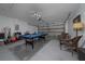 Spacious garage with painted floors and walls converted into a recreation space, featuring a pool table and seating at 2150 Flintlock Blvd, Kissimmee, FL 34743