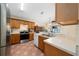 Charming kitchen features wood cabinets, stainless steel appliances, tile floors, and a view of the backyard at 2150 Flintlock Blvd, Kissimmee, FL 34743
