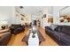 Inviting living room featuring wood floors, comfortable leather furniture, and an open dining area at 2150 Flintlock Blvd, Kissimmee, FL 34743
