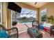 Enclosed patio featuring a pool view, comfortable seating, and a grilling area at 2150 Flintlock Blvd, Kissimmee, FL 34743