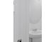 Modern bathroom featuring a pedestal sink, chrome fixtures, and a round mirror at 2188 Tay Wes Dr, St Cloud, FL 34771