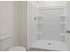Bright bathroom featuring a stand-up shower with built-in shelves and white walls at 2188 Tay Wes Dr, St Cloud, FL 34771