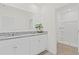 Bathroom featuring double sinks, granite countertops, white cabinets, and a large mirror at 2188 Tay Wes Dr, St Cloud, FL 34771