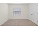 Carpeted bedroom with white walls, one window with blinds, and a double door closet at 2188 Tay Wes Dr, St Cloud, FL 34771
