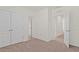 Carpeted bedroom with multiple doors, white walls, and a minimalist style at 2188 Tay Wes Dr, St Cloud, FL 34771