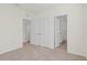 Bedroom view of the carpeted floor, white doors, and entrance to the bathroom at 2188 Tay Wes Dr, St Cloud, FL 34771