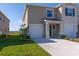 Well-manicured lawn and landscaping surround this two-story home with attached garage at 2188 Tay Wes Dr, St Cloud, FL 34771