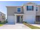Charming, two-story townhome with a private entrance, an attached garage, and simple landscaping at 2188 Tay Wes Dr, St Cloud, FL 34771