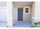 Inviting front entryway featuring a stylish blue door and convenient covered porch at 2188 Tay Wes Dr, St Cloud, FL 34771