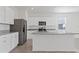 Modern kitchen featuring granite counters and white cabinets with stainless appliances at 2188 Tay Wes Dr, St Cloud, FL 34771