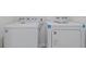 Clean laundry area with a side-by-side white washer and dryer at 2188 Tay Wes Dr, St Cloud, FL 34771