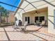 The screened lanai with an outdoor kitchen is perfect for enjoying beautiful days at home at 228 Sorrento Rd, Poinciana, FL 34759