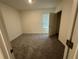 Neutral bedroom features plush carpet flooring, base trim, and window with blinds at 2755 Gentle Rain Dr, Davenport, FL 33837