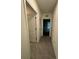 Hallway features tile floors and white doors leading to bedrooms and closets at 2755 Gentle Rain Dr, Davenport, FL 33837