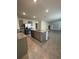 Open concept kitchen with granite countertops, stainless steel appliances, and tile floors at 2755 Gentle Rain Dr, Davenport, FL 33837