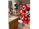 This bathroom has a granite sink and Mickey Mouse shower curtain at 2917 Kokomo Loop, Haines City, FL 33844