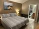 This bedroom features neutral walls, a king sized bed and ensuite bathroom at 2917 Kokomo Loop, Haines City, FL 33844