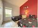 The bedroom features a vaulted ceiling, red accent wall and two twin beds at 2917 Kokomo Loop, Haines City, FL 33844