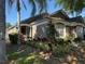 Charming single-story home with a well-maintained lawn, mature landscaping, and inviting entrance at 2917 Kokomo Loop, Haines City, FL 33844