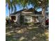 Charming single-story home featuring a landscaped front yard and neutral exterior paint, set beneath palm trees and a blue sky at 2917 Kokomo Loop, Haines City, FL 33844
