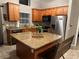 Modern kitchen with stainless steel appliances and granite countertop island at 2917 Kokomo Loop, Haines City, FL 33844