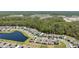 Neighborhood aerial shot with pond views and solar panels on rooftops nestled within a wooded area at 3010 Camden Way, Davenport, FL 33837