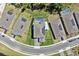 Aerial view of a modern home featuring a backyard pool, solar panels, and well-manicured landscaping at 3010 Camden Way, Davenport, FL 33837
