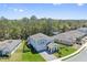Aerial view of a two-story home with landscaped yard, nestled in a lush green neighborhood at 3010 Camden Way, Davenport, FL 33837